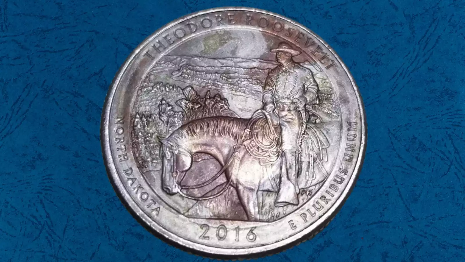 2016 quarter missing clad layer error showing copper-colored core exposed on one side with normal nickel surface on the other